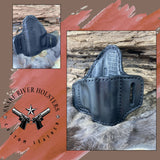 Black leather gun holster on a textured surface with 'Snake River Holsters' logo.